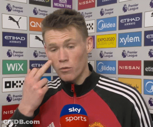 Man In Red And Black Jacket Speaking Into Sky Sports Microphone GIF
