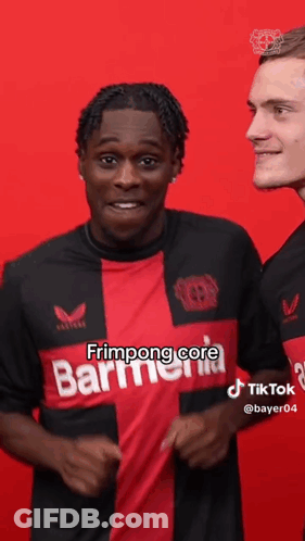 Man In Red And Black Shirt Next To Man In Black Shirt GIF