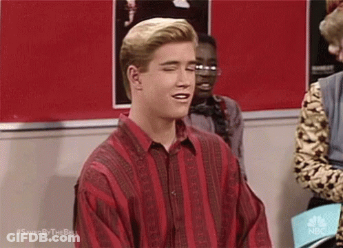 Man In Red And Black Striped Shirt In Front Of NBC Sign Saying Saved By The Bell GIF