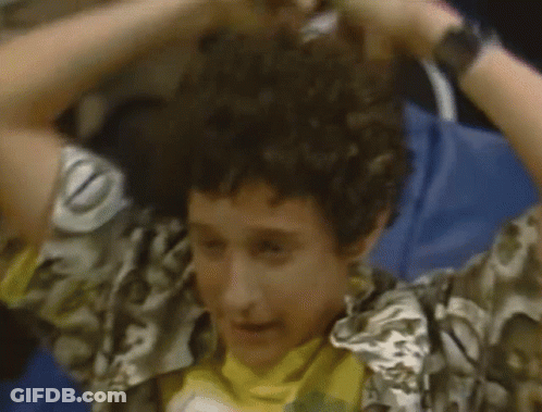 Man In Red And Black Striped Shirt In Front Of NBC Sign Saying Saved By The Bell GIF