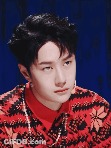 Man In Red And Black Sweater With Pearls GIF