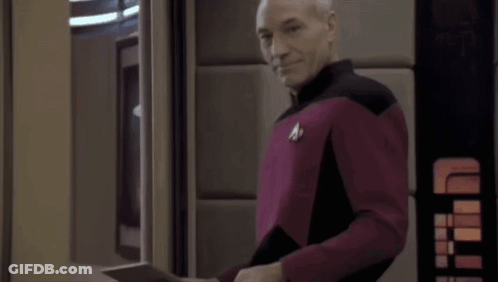 Man In Red And Black Uniform Holding Tablet GIF