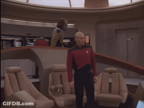 Man In Red And Black Uniform Standing In Room GIF