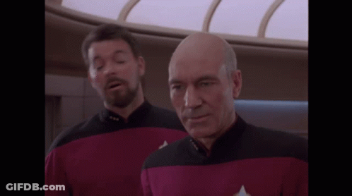 Man In Red And Black Uniform With Star Trek Badge GIF