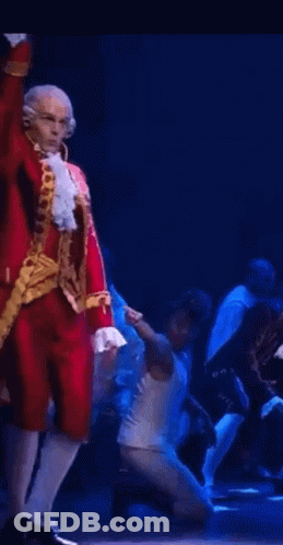 Man In Red And Gold Costume Dancing On Stage GIF