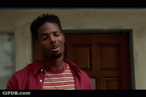 Man In Red And Striped Shirt Standing Before Door GIF