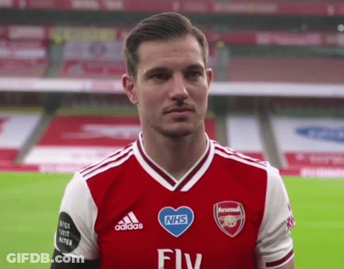 Man In Red And White Adidas Jersey With NHS Heart GIF