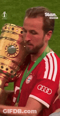 Man In Red And White Adidas Shirt Holding Trophy GIF