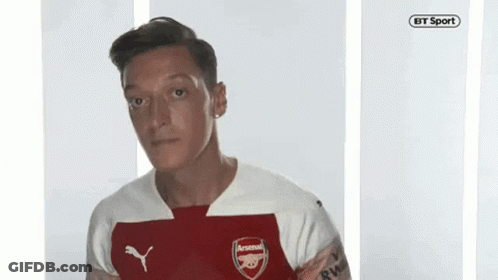 Man In Red And White Arsenal Jersey Looking At Camera GIF
