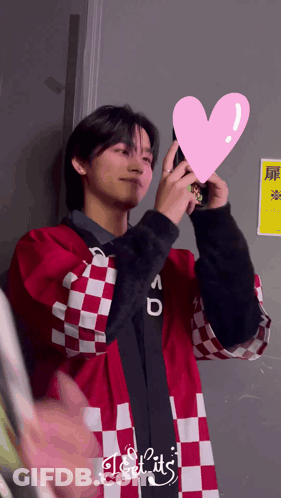 Man In Red And White Checkered Jacket Holding Pink Heart GIF