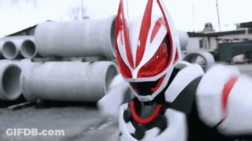 Man In Red And White Costume Standing In Front Of Pipes GIF