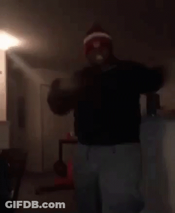 Man In Red And White Hat Dancing In Living Room With Woman On Floor GIF