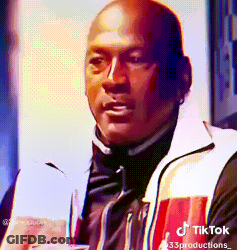 Man In Red And White Jacket Holding Drink Making Face GIF