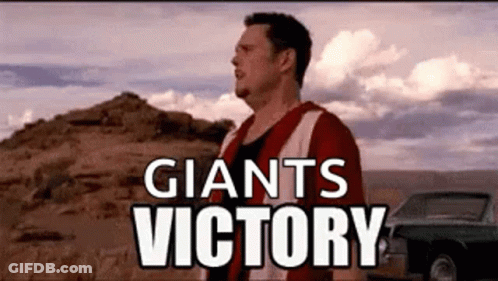 Man In Red And White Jersey Standing In Front Of Mountain And Car GIF