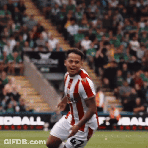 Man In Red And White Striped Jersey Running On Soccer Field GIF
