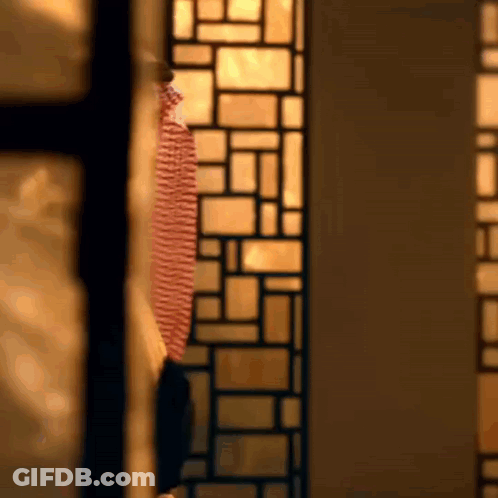 Man In Red And White Striped Shirt At Stained Glass Window GIF