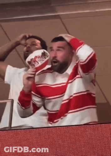 Man In Red And White Striped Shirt Holding Fan Saying Hot Dogs GIF