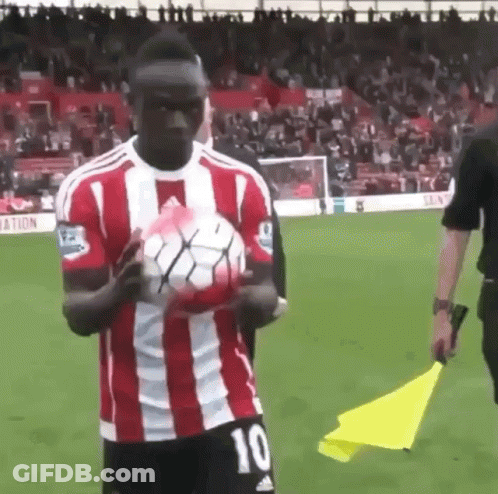 Man In Red And White Striped Shirt Holding Soccer Ball GIF