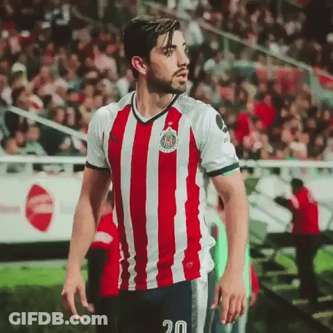 Man In Red And White Striped Shirt Number 20 GIF