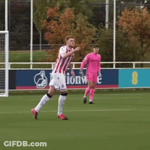 Man In Red And White Striped Shirt Running On Soccer Field GIF