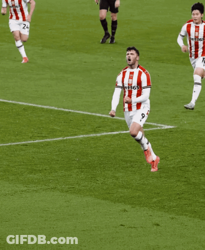 Man In Red And White Striped Shirt Running On Soccer Field GIF