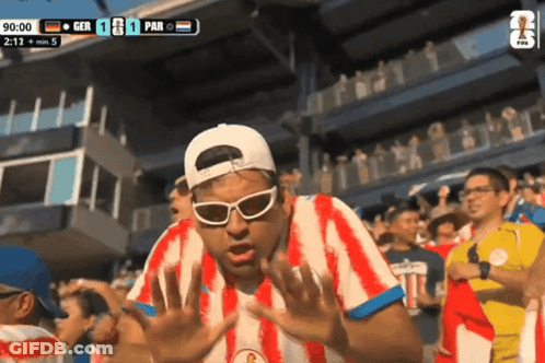Man In Red And White Striped Shirt Watching GER Vs PAR Soccer GIF