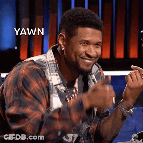 Man In Red And White Sweater Smiling At Table GIF