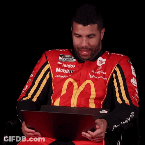 Man In Red And Yellow McDonald's Shirt Looking At Laptop GIF