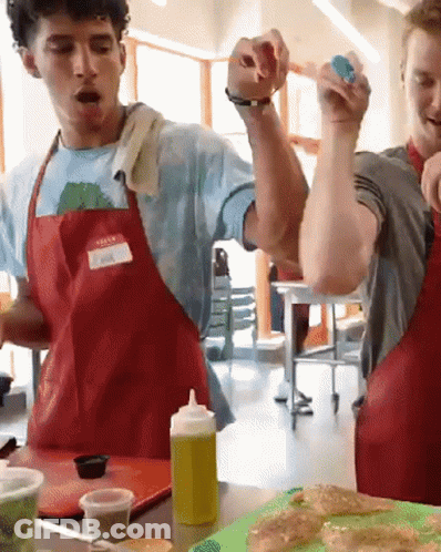 Man In Red Apron With Name Tag Spencer GIF