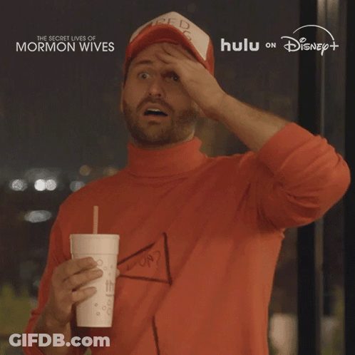 Man In Red Bag Hat Holding Drink GIF