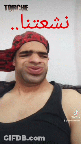Man In Red Bandana And Black Tank Top Making Funny Face Saying Torche GIF