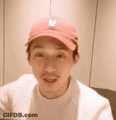 Man In Red Baseball Cap And White Sweater Smiling GIF