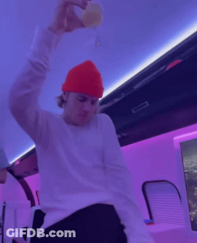 Man In Red Beanie Holding Champagne GIF