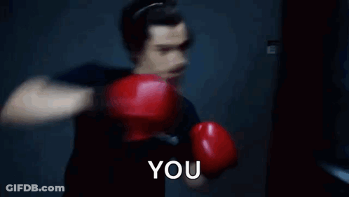 Man In Red Boxing Gloves Punching Bag Saying You GIF