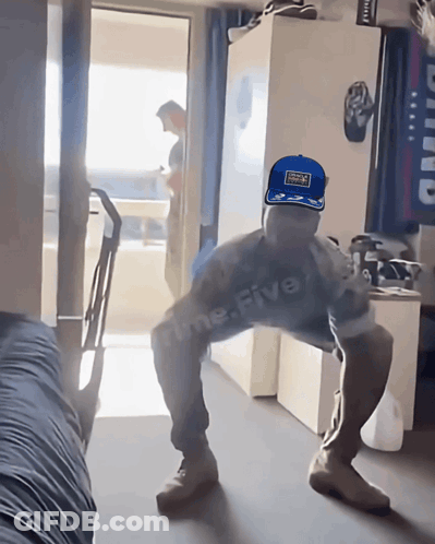 Man In Red Bull Cap Squatting GIF