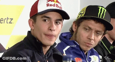Man In Red Bull Hat Beside Monster Hat GIF