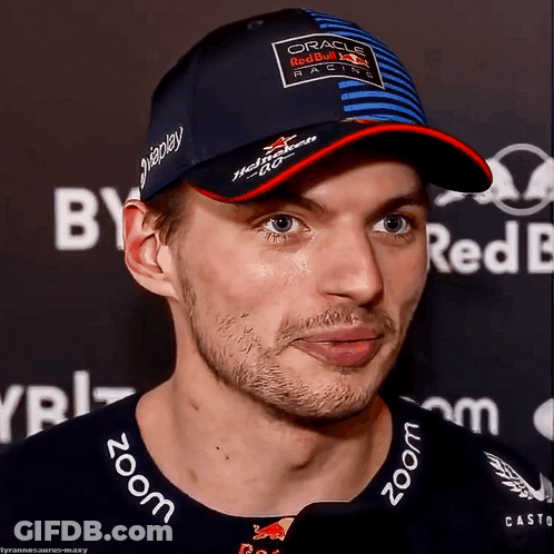 Man In Red Bull Hat Looking At Camera GIF
