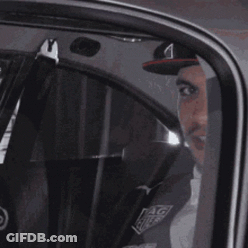 Man In Red Bull Hat Sitting In Car GIF