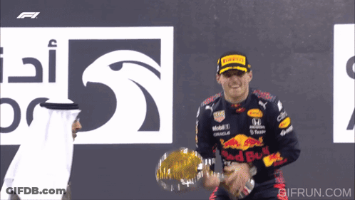 Man In Red Bull Jacket Holding Trophy GIF
