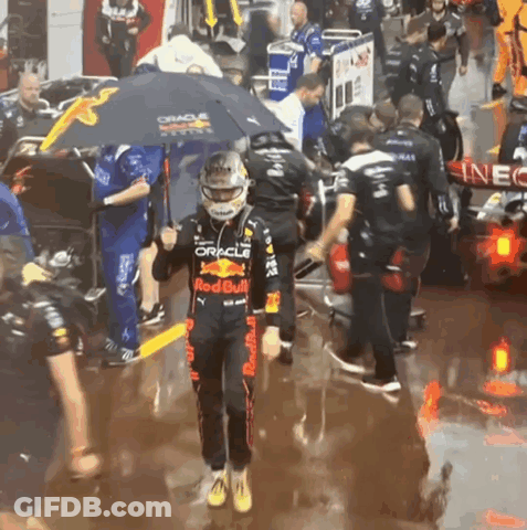 Man In Red Bull Outfit Holding Umbrella Over Head GIF
