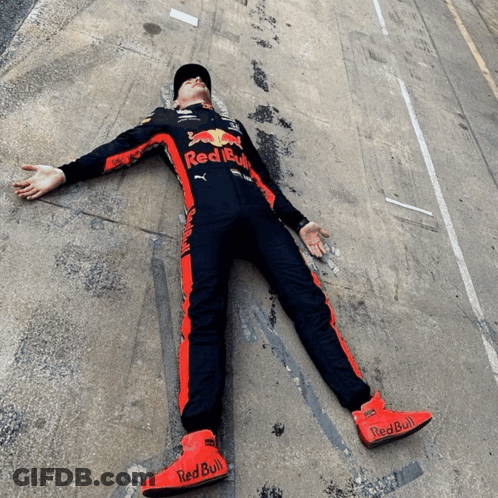Man In Red Bull Outfit Lying With Arms Outstretched GIF