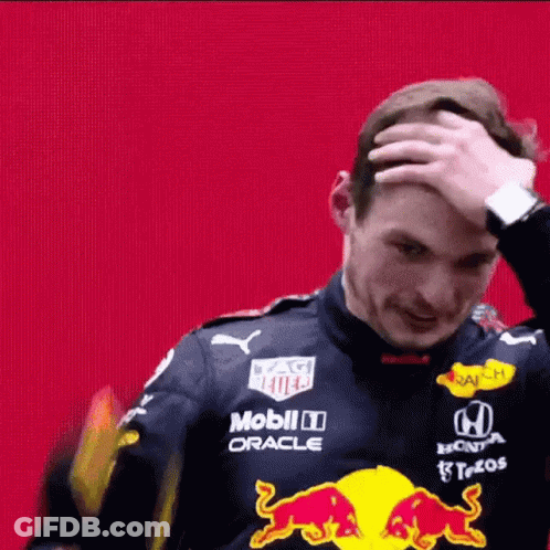 Man In Red Bull Racing Suit Scratching Head GIF