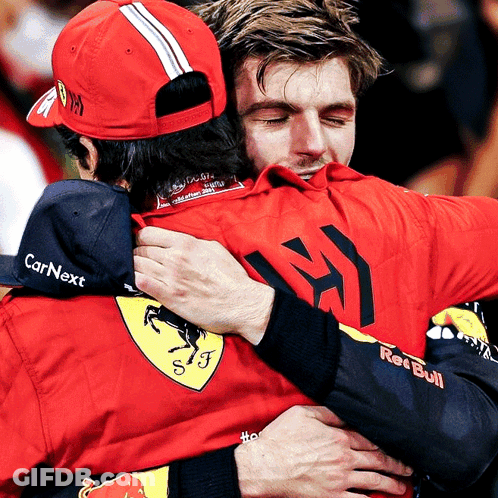 Man In Red Bull Shirt Hugging Man In CarNext Hat GIF