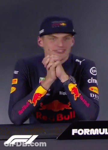 Man In Red Bull Shirt Sitting At Table GIF