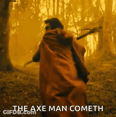 Man In Red Cape Holding Axe In Forest GIF