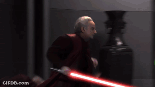 Man In Red Cape Holding Lightsaber GIF