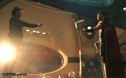 Man In Red Cape Next To Man In Black Shirt GIF
