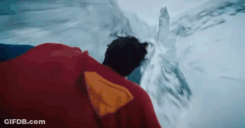 Man In Red Cape Standing By Water GIF