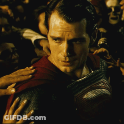 Man In Red Cape Surrounded By Crowd GIF