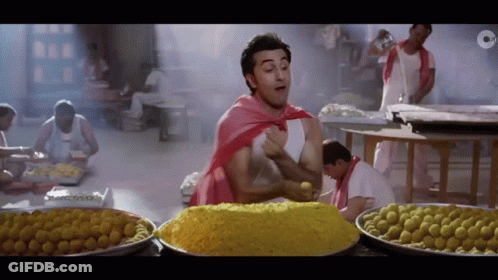 Man In Red Cape With Pile Of Food GIF